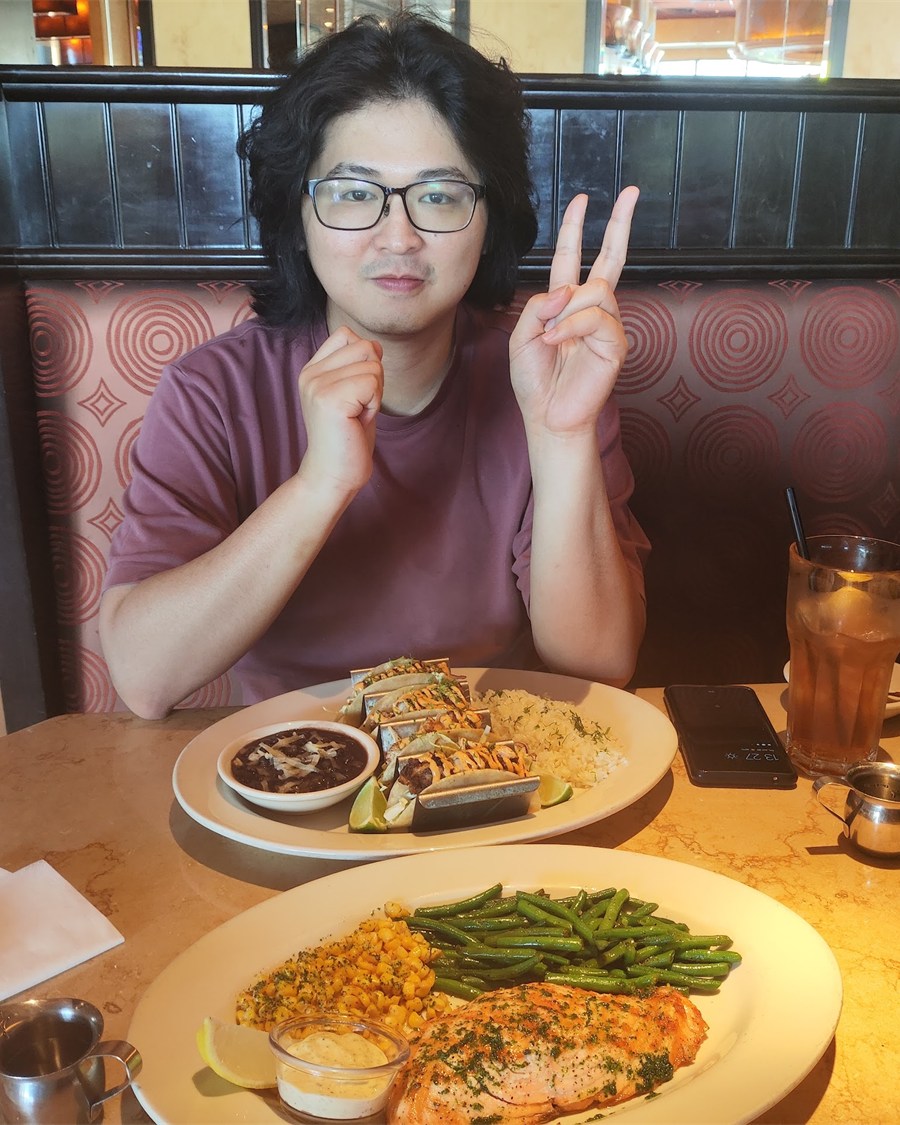Wei-Cheng Lee seated at a restaurant table